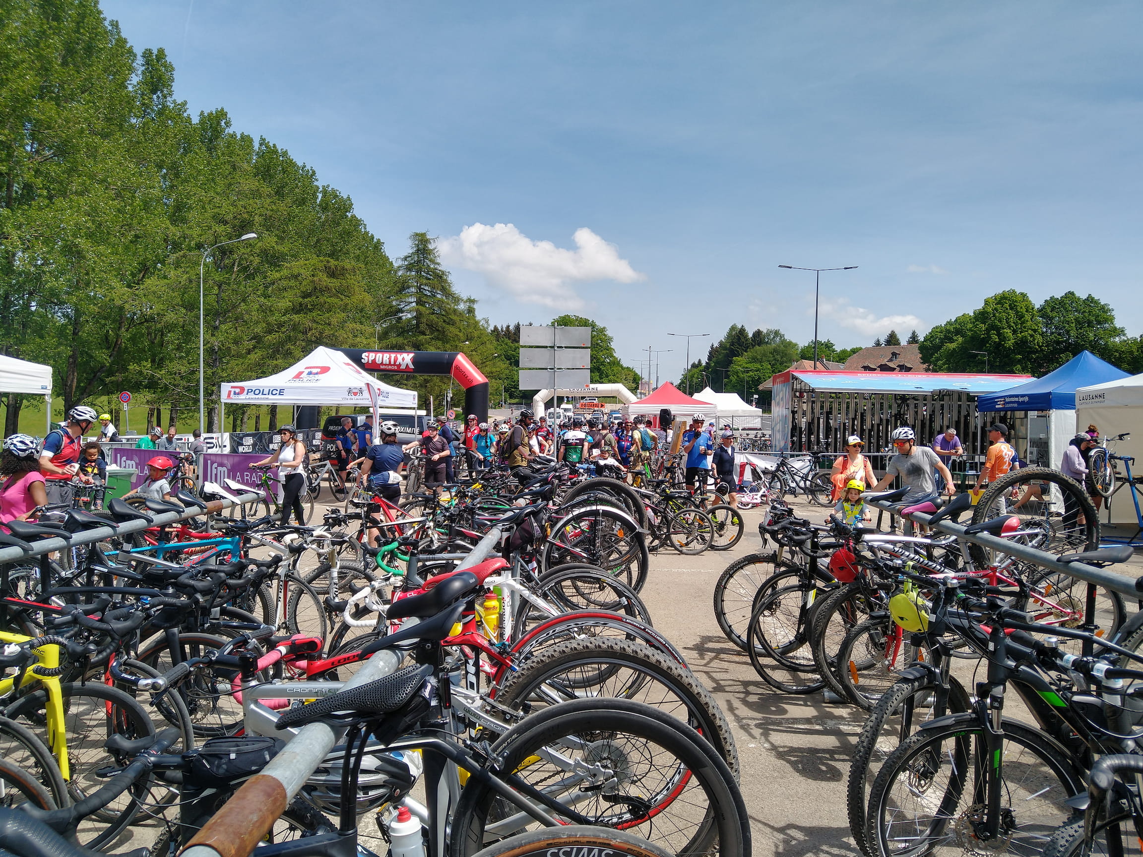The bicycle parking is surrounded by booths offering food, beverages and massages